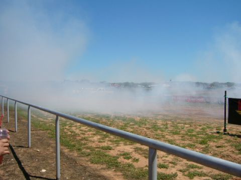 1978 Ford Bronco - A truck performs a burnout, creating a large cloud of smoke against a clear blue sky.