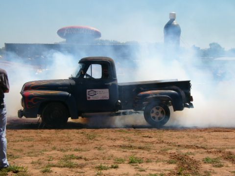1978 Ford Bronco - This classic Ford pickup is kicking up a lot of smoke during a burnout. The Flowmaster blimp is visible in the distance.