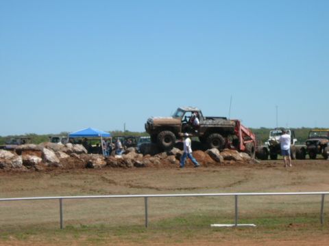 1978 Ford Bronco - A modified truck navigates a rocky obstacle course during an outdoor event.