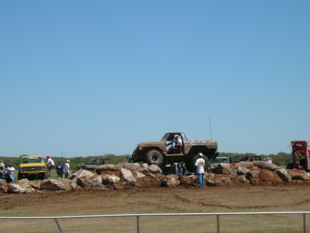 Brown off-road vehicle climbing rocks, 3q-front view. 1979 model