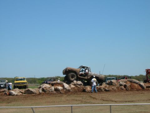 1978 Ford Bronco - A 1978 Ford Bronco navigates a rocky obstacle course during an event.