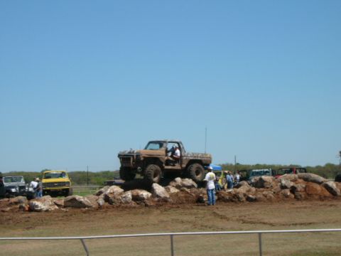 1978 Ford Bronco - A lifted 1979 pickup truck navigates a rocky obstacle course on a sunny day.