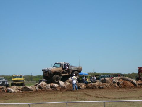 1978 Ford Bronco - Off-road truck navigates a rocky obstacle course on a clear day.