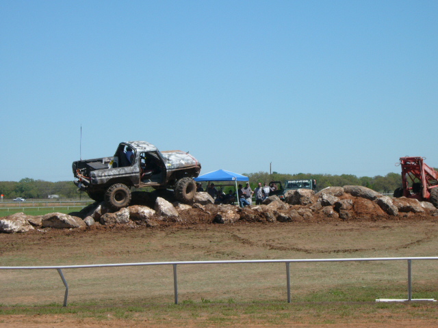 1978 Ford Bronco climbing over a rock obstacle course