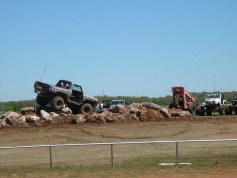 1978 Ford Bronco - Multiple off-road vehicles, including a 1978 Ford Bronco, tackle a challenging obstacle course.