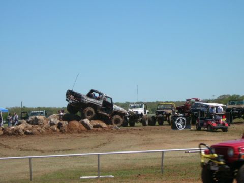1978 Ford Bronco - A 1978 Ford Bronco navigates a rocky obstacle course with other off-road vehicles in the background.