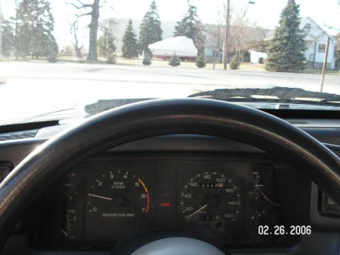 1988 Ford Mustang - Interior view of a 1988 Ford Mustang, displaying the dashboard gauges and steering wheel.