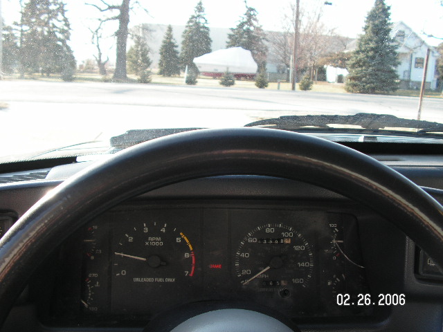 1988 Ford Mustang interior showing dashboard gauges and steering wheel. Date stamp 02.26.2006