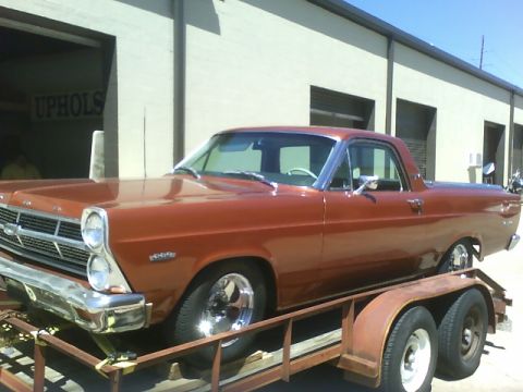 1979 Ford Ranchero - This copper Ford Ranchero is loaded onto a trailer in front of a commercial building.