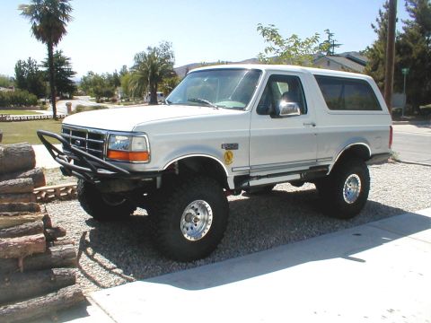 1996 Ford Bronco - This 1996 Ford Bronco features a custom front bumper and is lifted with large off-road tires.