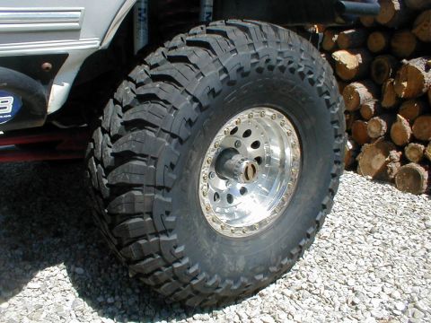 1996 Ford Bronco - A close-up view of a large off-road tire and wheel assembly on a modified vehicle.