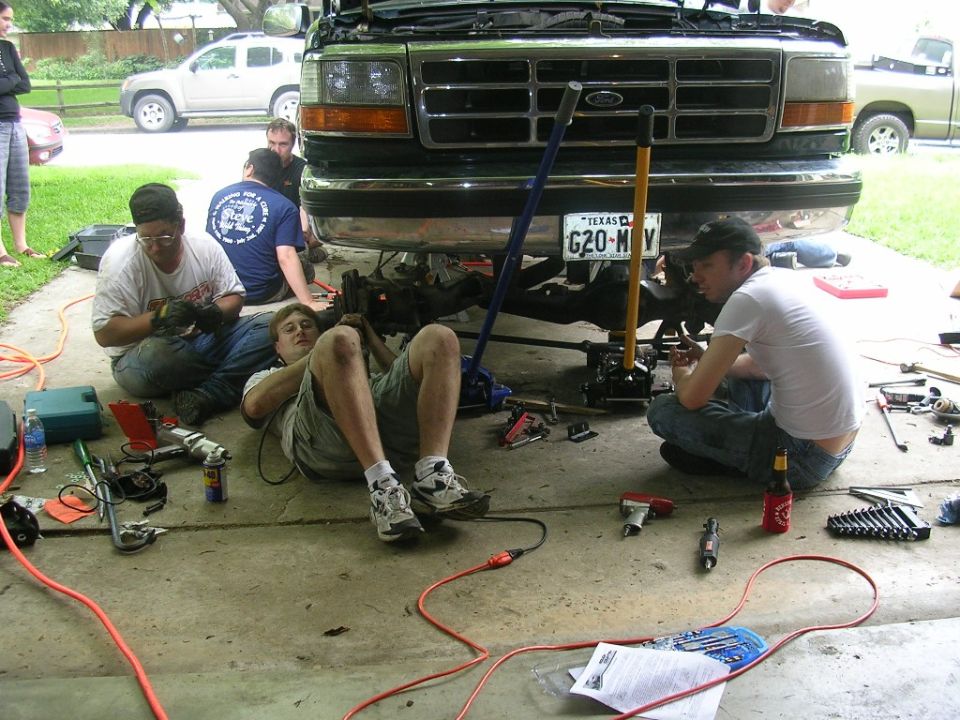 1994 Ford Bronco front view with people working underneath