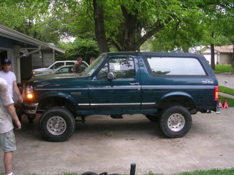1994 Ford Bronco - This 1994 Ford Bronco is seen in a driveway with another vehicle in the background.
