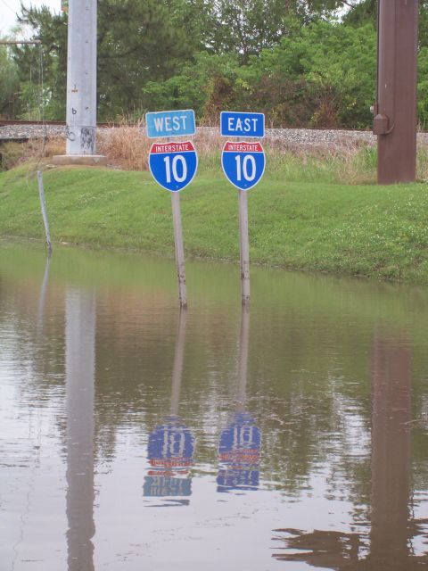 1992 Ford Bronco - Interstate 10 signs stand in floodwaters, indicating West and East directions.