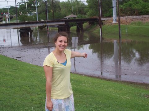 1992 Ford Bronco - A woman points at a flooded road under a bridge, indicating the extent of the water.