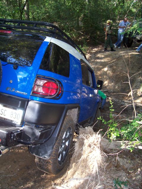 1992 Ford Bronco - Toyota FJ Cruiser navigating a challenging off-road trail with onlookers present.