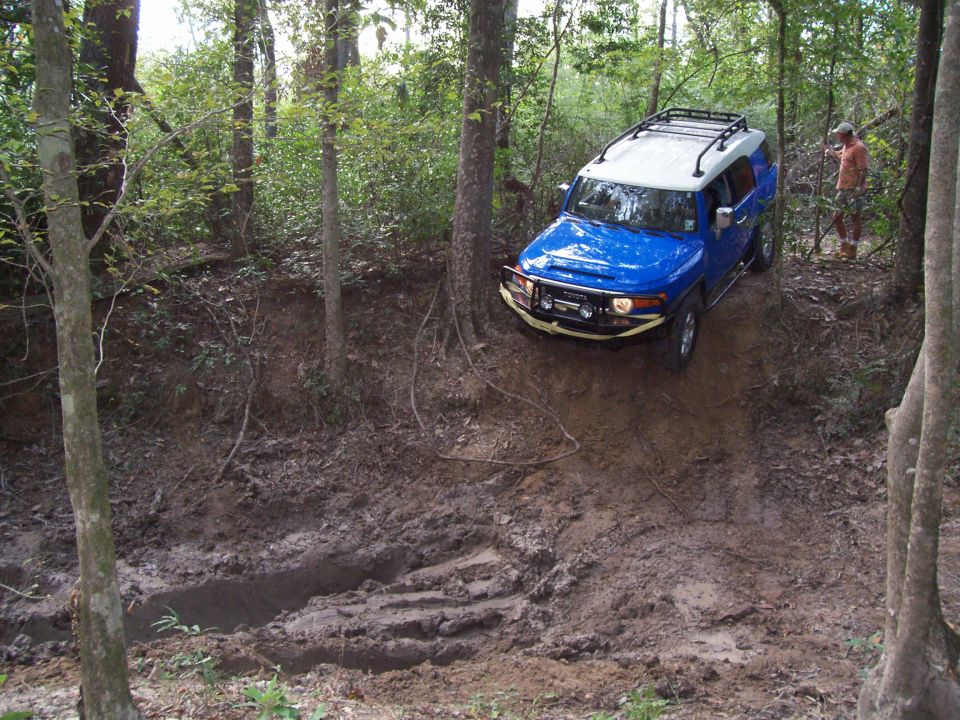 Blue Toyota FJ Cruiser on a muddy trail