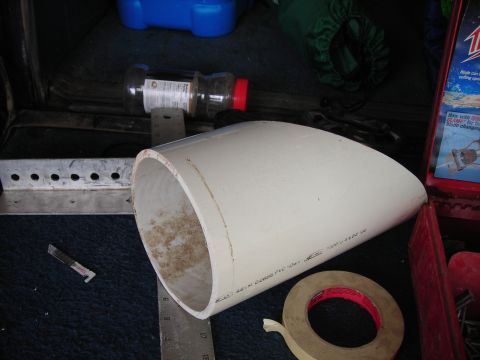 1994 Ford Bronco - A white PVC pipe lies on dark carpet next to a roll of tape and a ruler.
