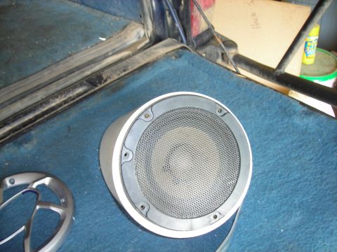 1994 Ford Bronco - A car speaker is visible on the blue carpeted floor of a vehicle.