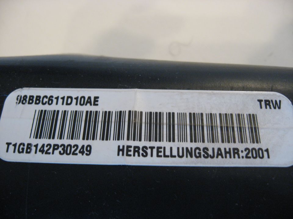TRW part label 98BBC611D10AE with barcode and HERSTELLUNGSJAHR 2001 on black plastic part