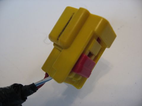 2001 Ford Crown Victoria - Close-up of a yellow electrical connector with a red locking tab and attached wires.