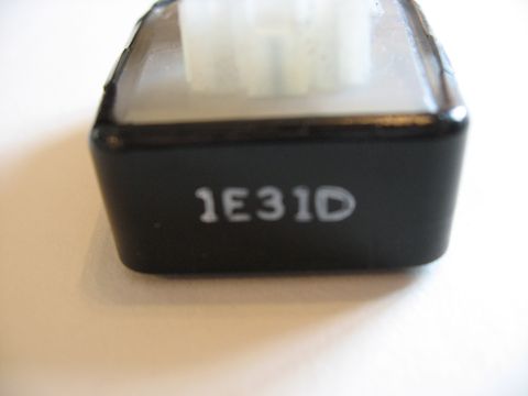 2001 Ford Crown Victoria - A black automotive part is shown with the identifier 1E31D printed in white.