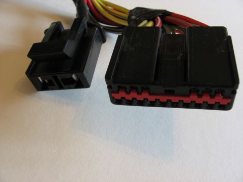 2001 Ford Crown Victoria - Two black automotive wiring harness connectors are shown, one with a red locking mechanism and a bundle of multi-colored wires.