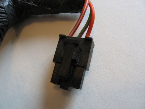 2001 Ford Crown Victoria - Close-up of a wiring harness connector with two wires emerging from a black protective sleeve.