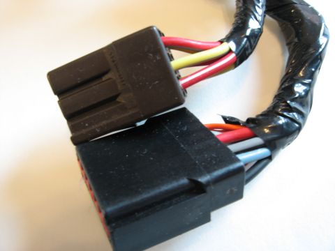 2001 Ford Crown Victoria - A close-up view of two automotive wiring harness connectors, one brown and one black, with visible wires.