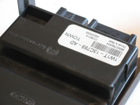 2001 Ford Crown Victoria - This is a Ford electronic control module, part number 1W1T-13C789-AD, likely for the driver's seat.