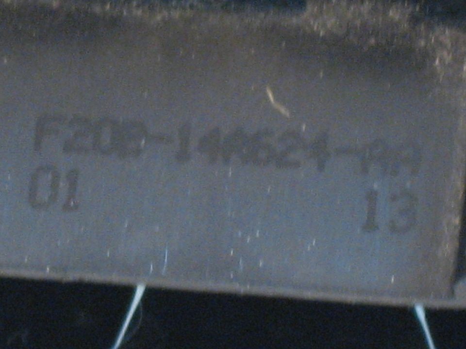 Ford part number F2DB-14A624 molded into grey plastic component