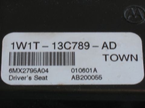 2001 Ford Crown Victoria - A close-up view of a label on a vehicle part, showing identification numbers and text.
