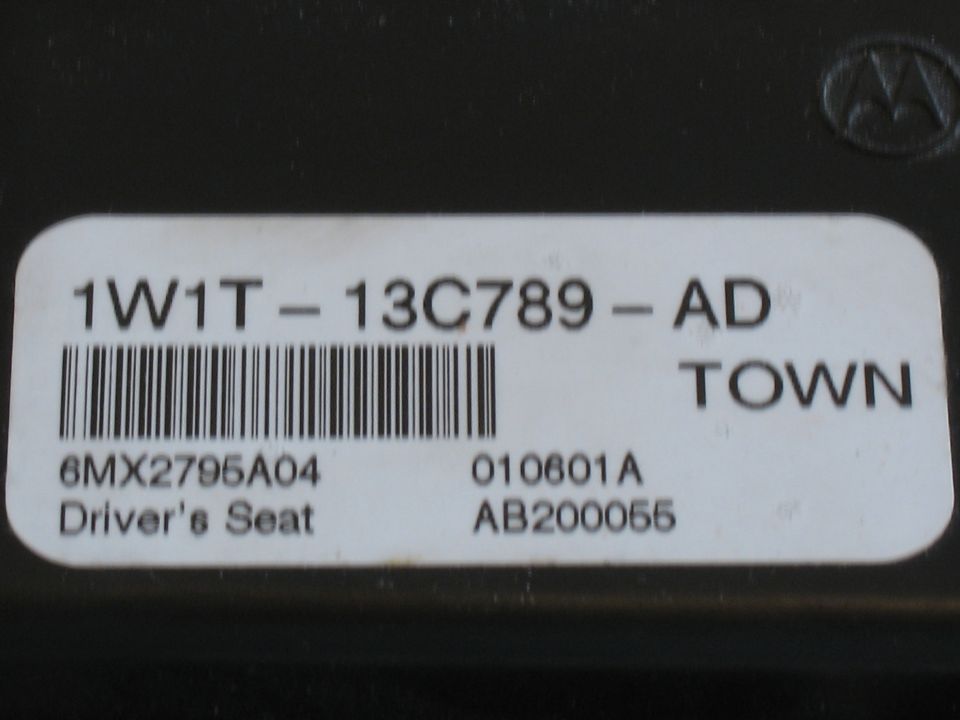 Label on a part reads 1W1T-13C789-AD TOWN, with a barcode and 'Driver's Seat' text