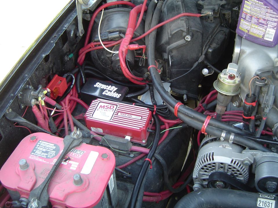 Engine bay with red MSD ignition box, red battery and alternator