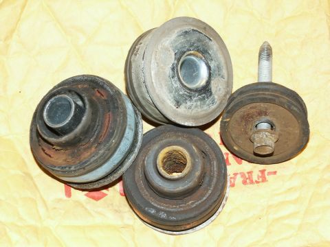 2001 Mercury Grand Marquis - These are four used body mounts, likely for a vehicle, shown on a yellow paper background.