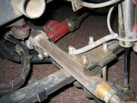 1987 Suzuki Samurai - Undercarriage view shows steering linkage and suspension components, including a red-housed component and leaf springs.