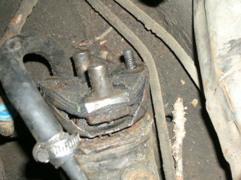 1978 Ford E250 - This is a close-up view of a vehicle's steering box mount, showing wear and tear.