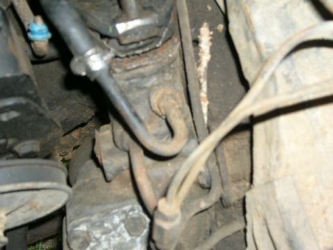1978 Ford E250 - Close-up view of a vehicle's steering box and rag joint assembly.