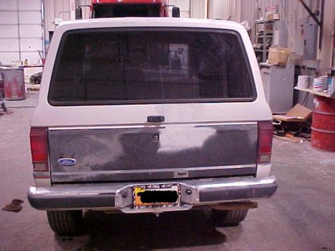 1990 Ford Bronco II - The rear of a Ford Bronco II is visible in a workshop setting.
