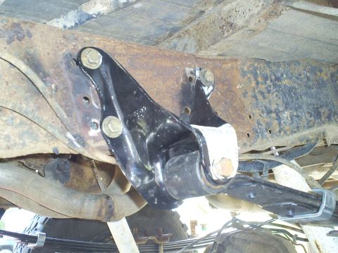 1994 Ford F-250 - Close-up view of a modified suspension component attached to a heavily rusted frame, a Supermotors.net watermark.