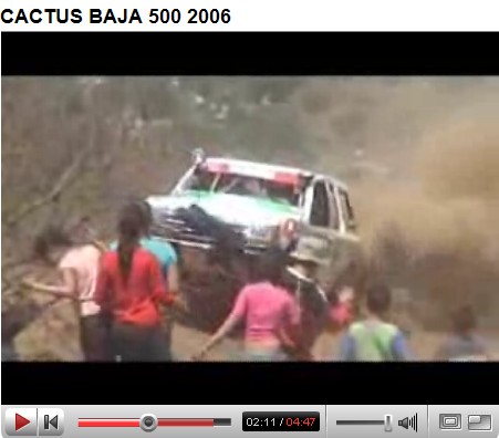 1992 Ford Explorer - An off-road vehicle navigates a dusty course with onlookers present.