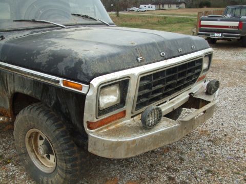 1979 Ford Bronco - Front view of a black Ford truck, a prominent grille and bumper, consistent with a 1979 model year.