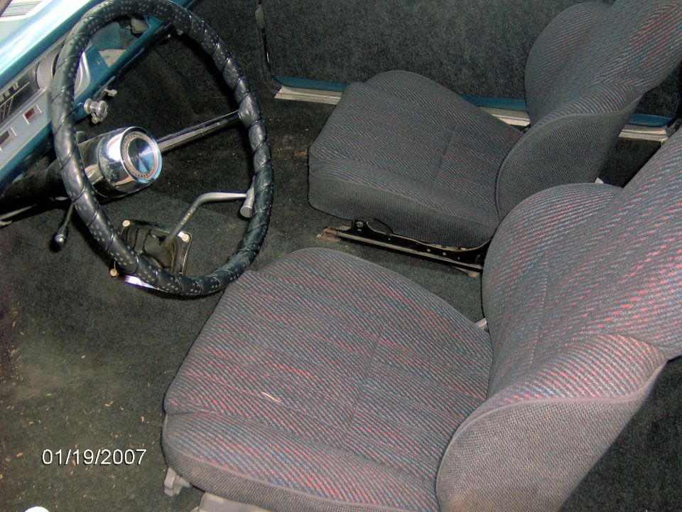 Interior view of a car with cloth seats and a black steering wheel. Date stamp reads 01/19/2007
