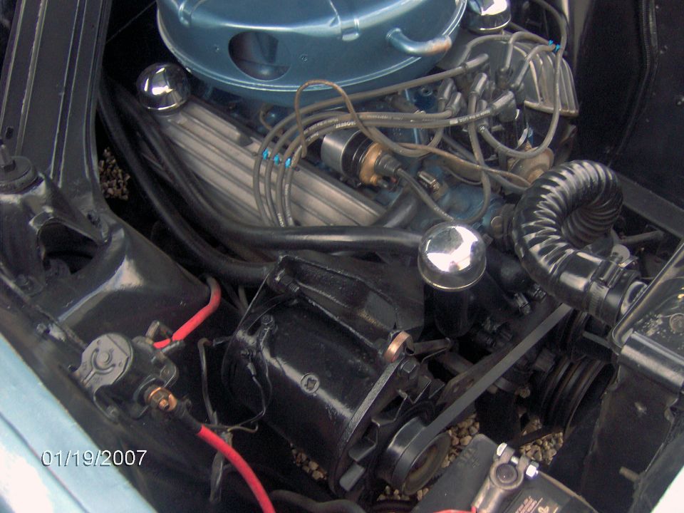 Engine bay view of a V8 engine, showing distributor, spark plug wires, and alternator. Date stamp 01/19/2007