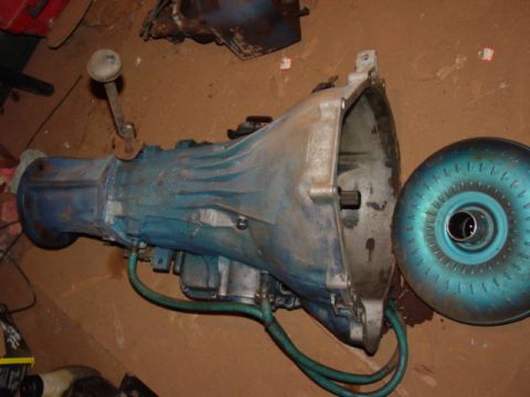 1986 Ford Bronco - A disassembled automatic transmission and its torque converter are shown on a floor.