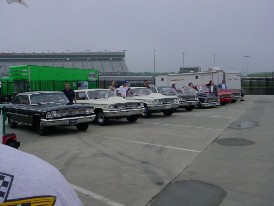 Line of classic cars, including a black 1964 Ford Galaxie