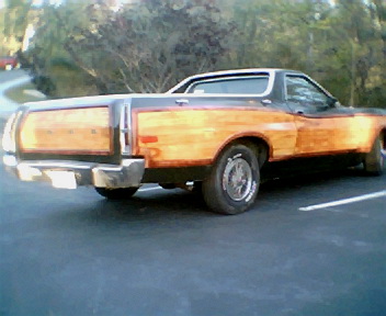 1973 Ford Ranchero - The rear of a 1973 Ford Ranchero pickup truck, distinctive wood paneling on its sides.