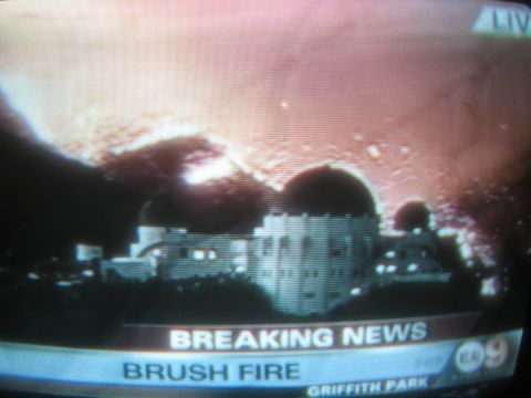 1968 Ford Mustang - News footage shows Griffith Observatory as a brush fire burns in the background, with breaking news text on screen.