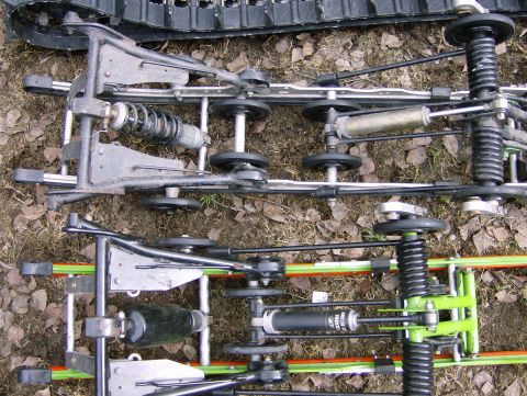 1982 Chevrolet C/K Pickup - Two different snowmobile suspension systems are shown side-by-side, highlighting their mechanical complexity.