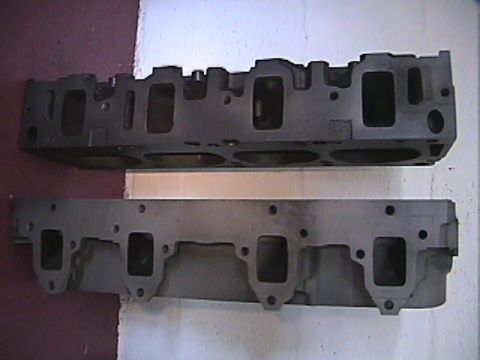 1968 Mercury Cougar - A pair of engine cylinder heads are displayed, likely for an automotive engine rebuild or industrial application.
